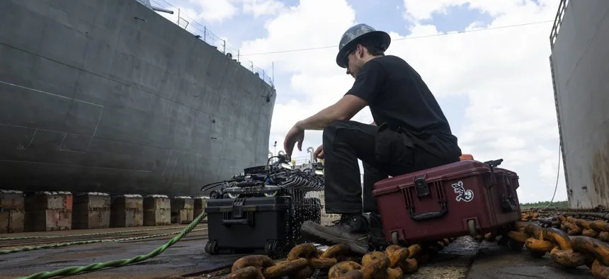 Tehnician pregătind un robot pe o navă militară