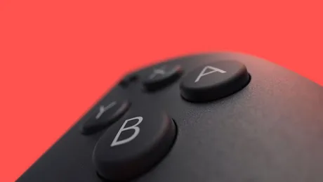 Controler Nintendo cu butoane vizibile pe fundal roșu.