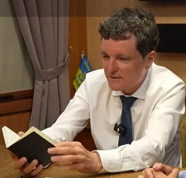 Nicușor Dan consultându-și carnețelul în biroul său.