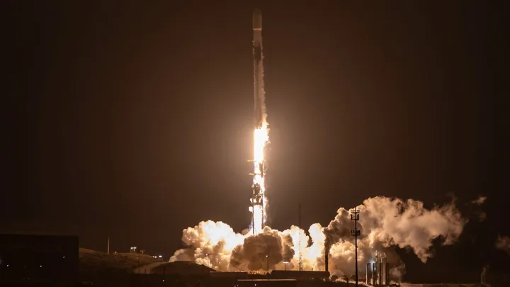 Lansarea rachetei Falcon 9 de la baza Vandenberg în noaptea întunecată.