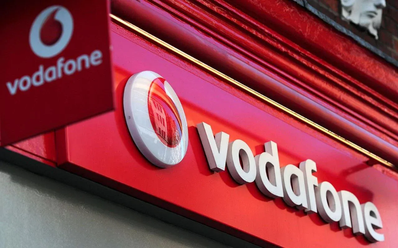 Logo Vodafone pe fundal roșu, simbolizând creșterea tarifelor.