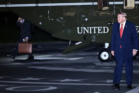 Donald Trump pe aeroport, discutând despre armistițiul energetic între Rusia și Ucraina.