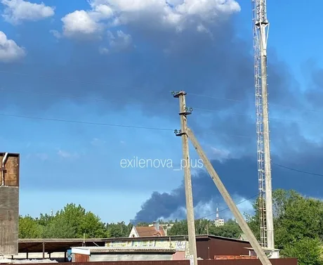 Fum gros se ridică deasupra unei zone industriale afectate de un incendiu.