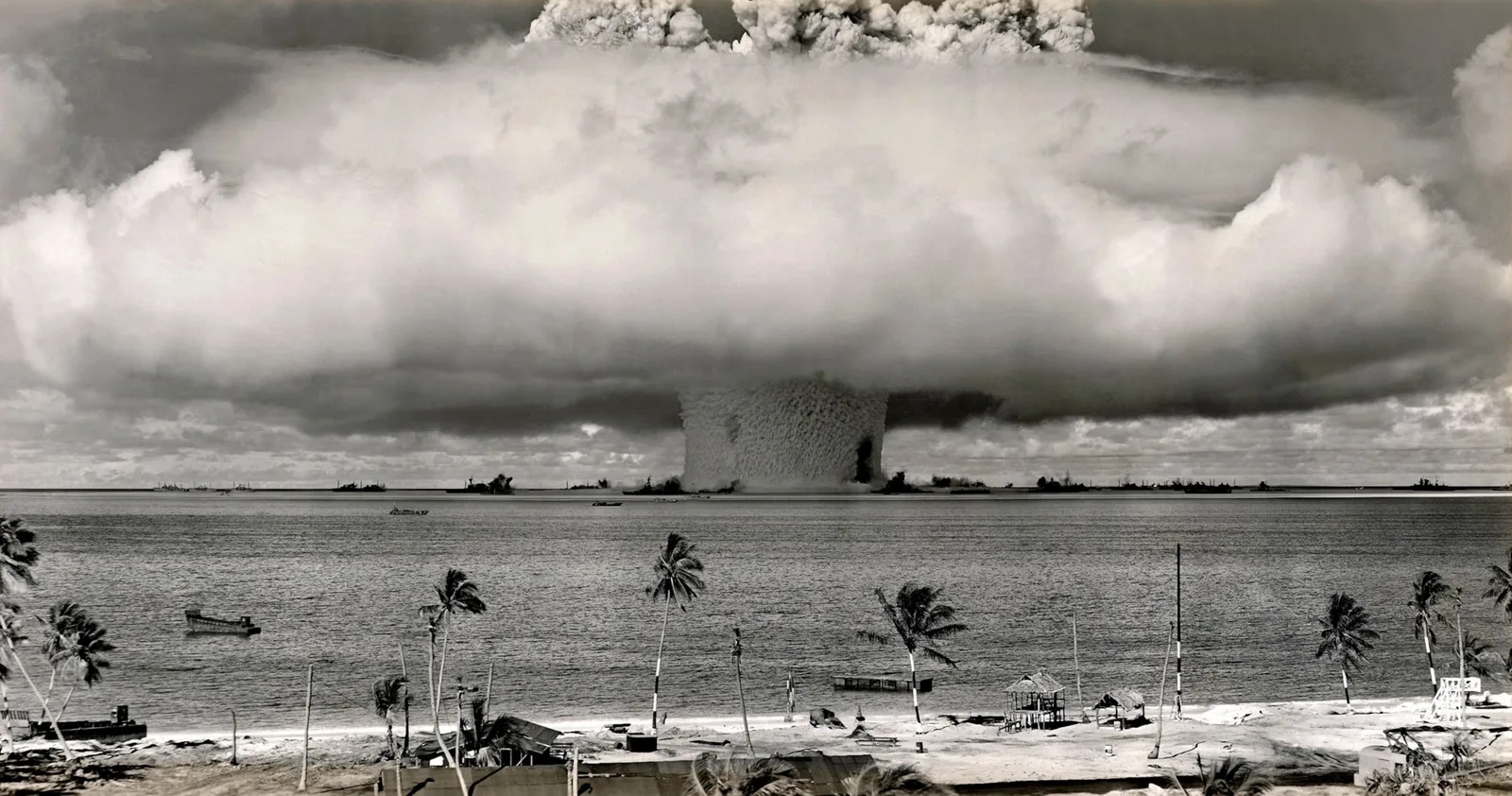 Explozie nucleară sub un nor de fum pe fundalul mării.