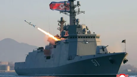 Nava militară nord-coreeană lansând o rachetă în apă, simbolizând provocările regionale.