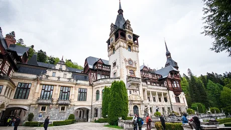 Castelul Peleș, un obiectiv turistic emblematic din România, înconjurat de natură.
