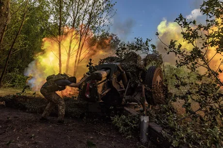 Explozie pe frontul ucrainean, soldat operând o armă în mijlocul conflictului.