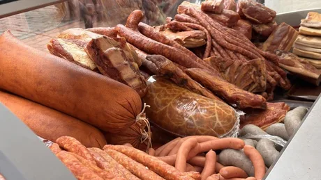 Produse din carne expuse pe un stand de vânzare.