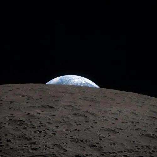 Vedere asupra Pământului de pe Lună, cu crater lunar în prim-plan.
