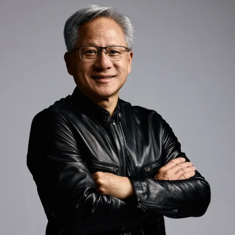 Jensen Huang zâmbește în timp ce poartă o jachetă neagră.