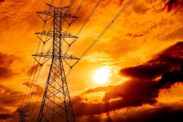 Stâlpi de electricitate în apus, simbolizând provocările energetice.