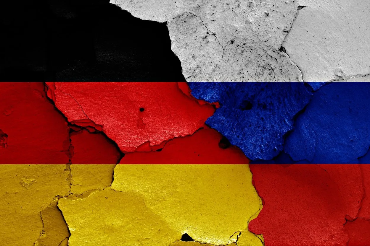 Steaguri ale Germaniei și Rusiei pe un fundal crăpat, simbolizând tensiuni geopolitice.