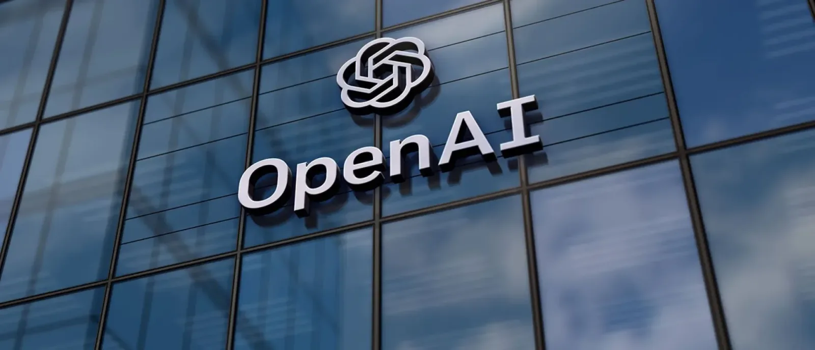 Logo-ul OpenAI pe o clădire modernă din sticlă.
