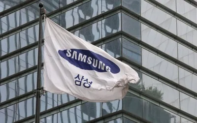 Steagul Samsung fluturând lângă clădiri moderne din sticlă.