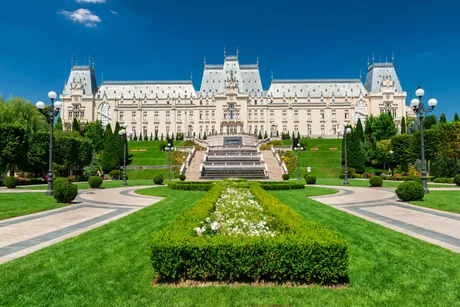 Palatul Culturii din Iași, un simbol al arhitecturii românești, înconjurat de verdeață.