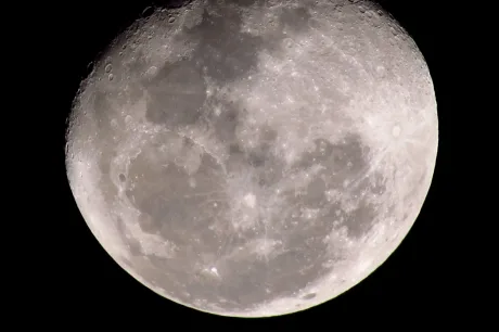 Crater lunar vizibil pe suprafața Lunii, rezultat din impact.