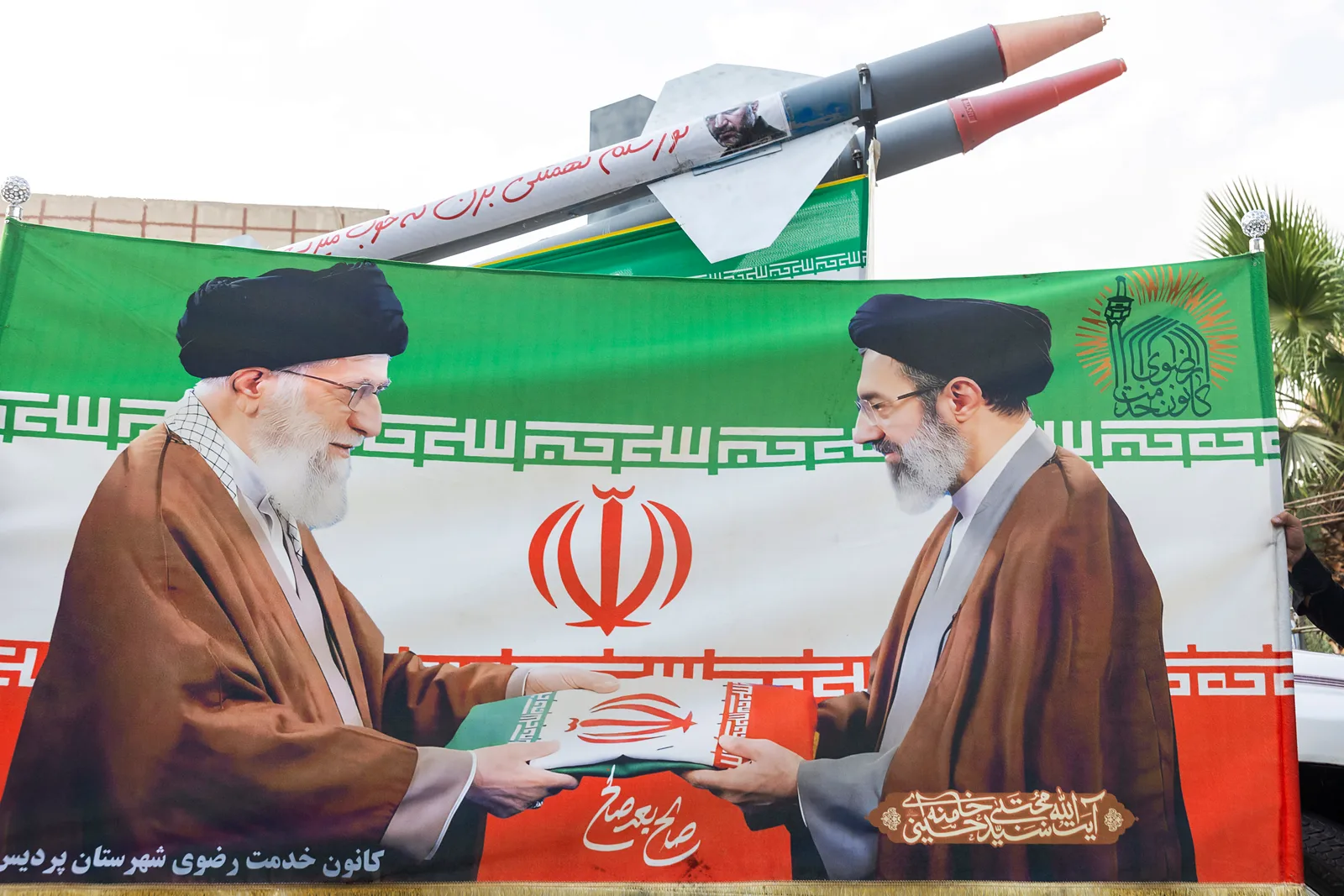 Banner cu lideri iranieni și rachete, simbolizând tensiuni internaționale.