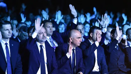 Membri PNL ridicând mâinile în semn de vot la o întâlnire politică.