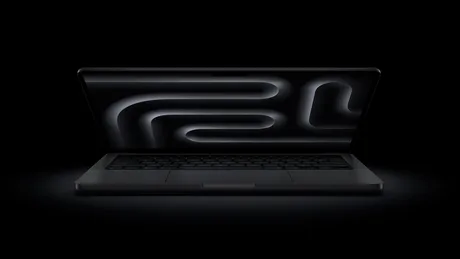Laptop Apple MacBook Pro cu un design elegant, pe fundal întunecat.