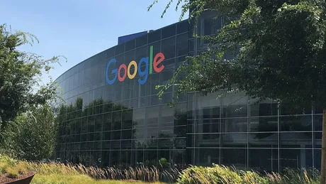 Clădirea Google cu sigla colorată pe fațadă, înconjurată de vegetație.