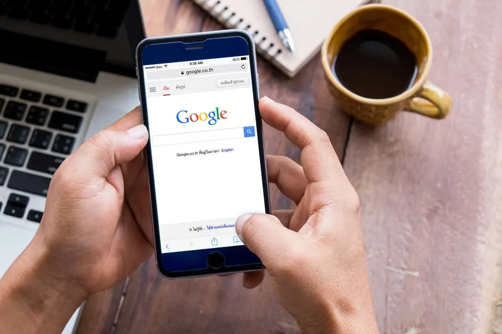 Utilizator căutând informații pe Google de pe un telefon mobil.