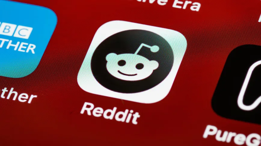 Logo-ul Reddit pe un fundal roșu, simbolizând comunitățile online.