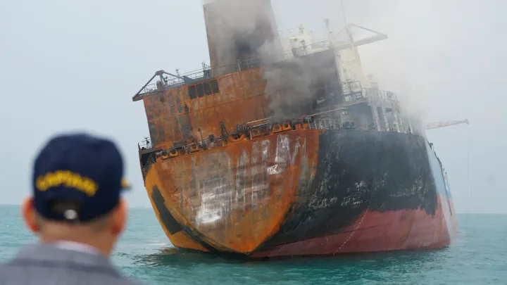 Vapor în flăcări, simbolizând riscurile transportului maritim de petrol.