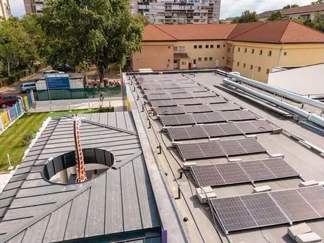 Panouri fotovoltaice instalate pe acoperișul unei clădiri publice.
