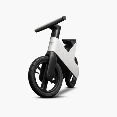 Bicicletă de echilibru Tesla pentru copii, design minimalist alb-negru.