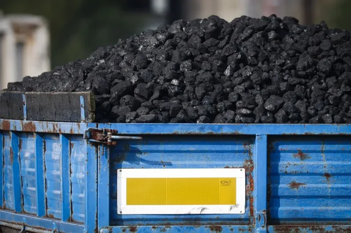 Morman de cărbune într-un container albastru, pregătit pentru utilizare.