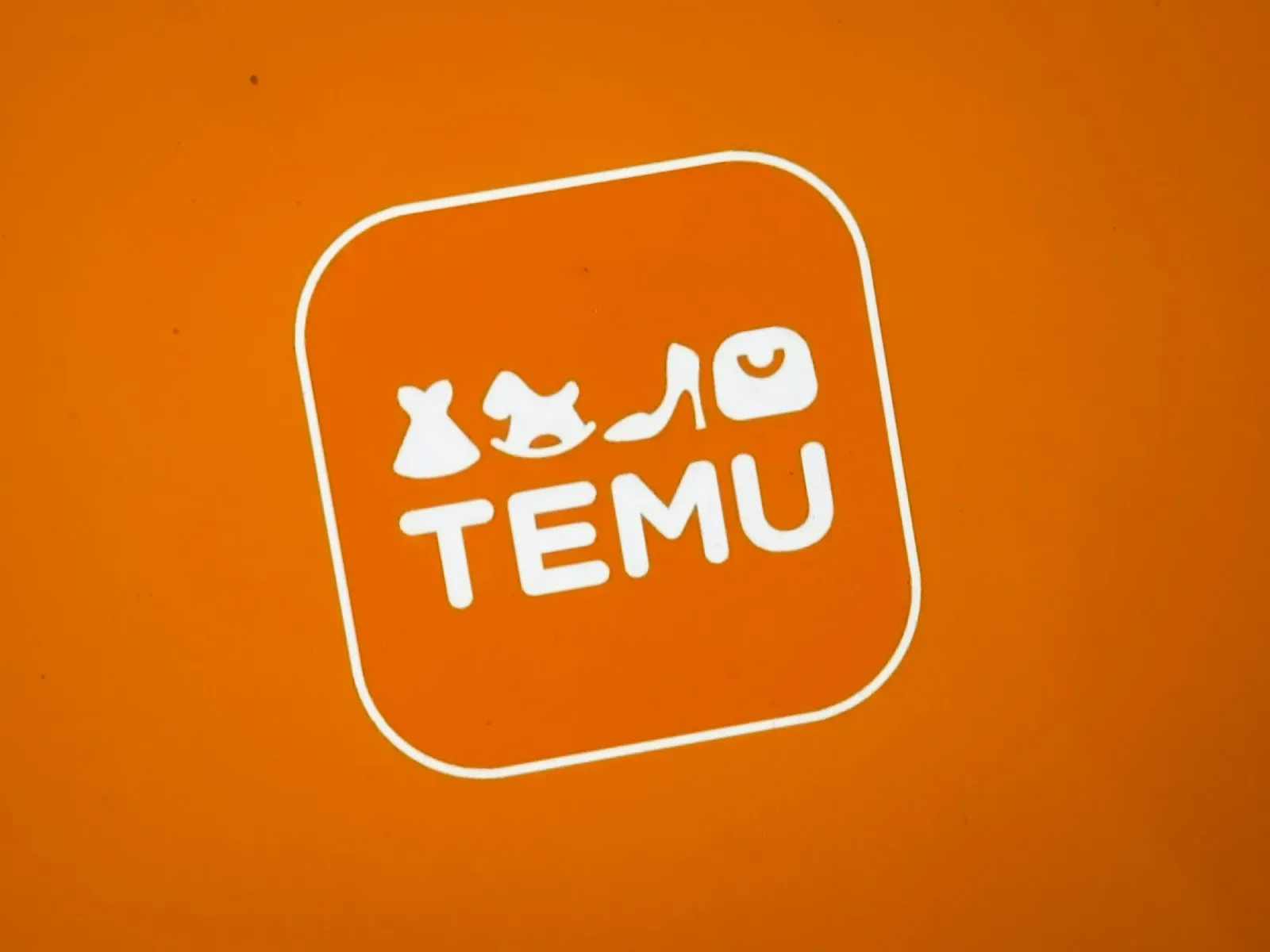 Logo-ul platformei Temu pe fundal portocaliu.