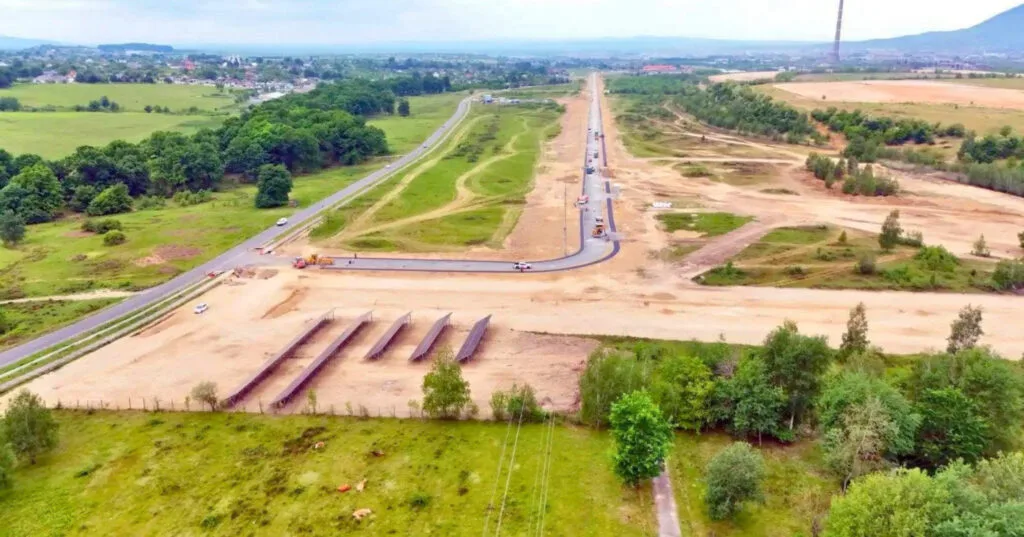 Peisajul unui parc industrial în dezvoltare, cu drumuri și terenuri pregătite pentru construcții.