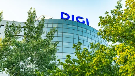 Clădirea DIGI înconjurată de copaci verzi, simbol al contribuției fiscale.