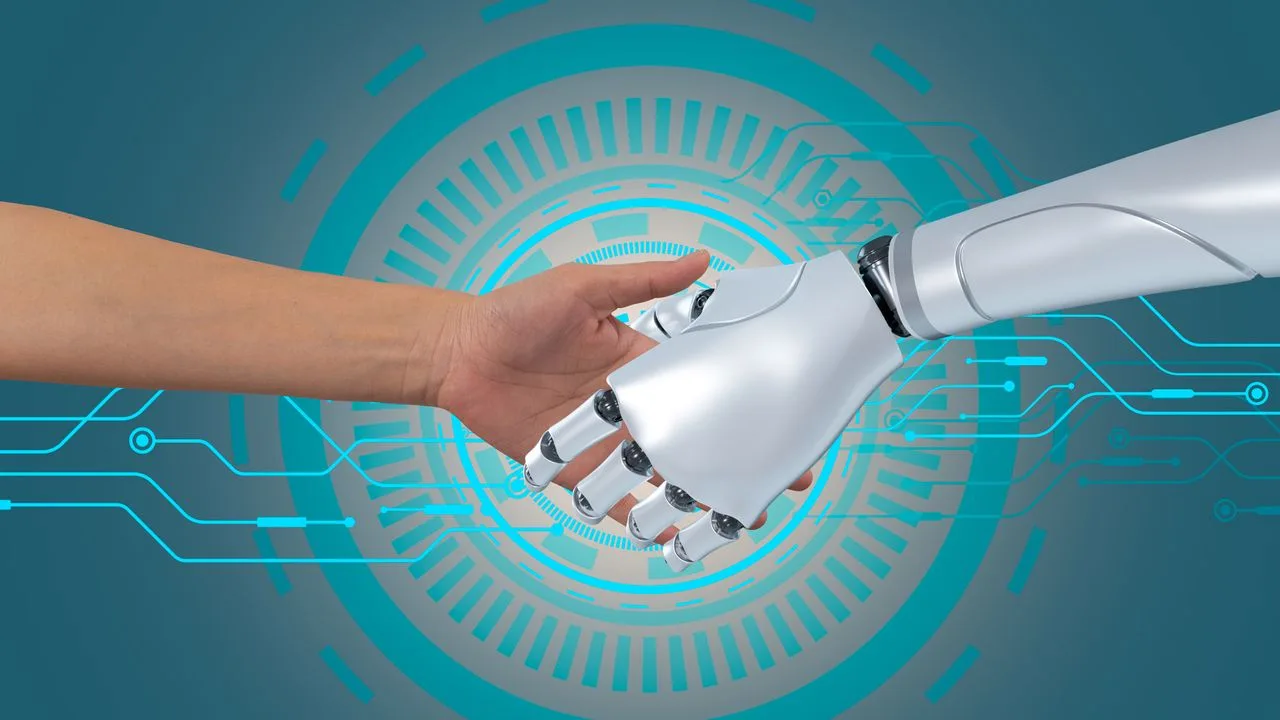 Interacțiune între un robot și o mână umană, simbolizând colaborarea tehnologică.