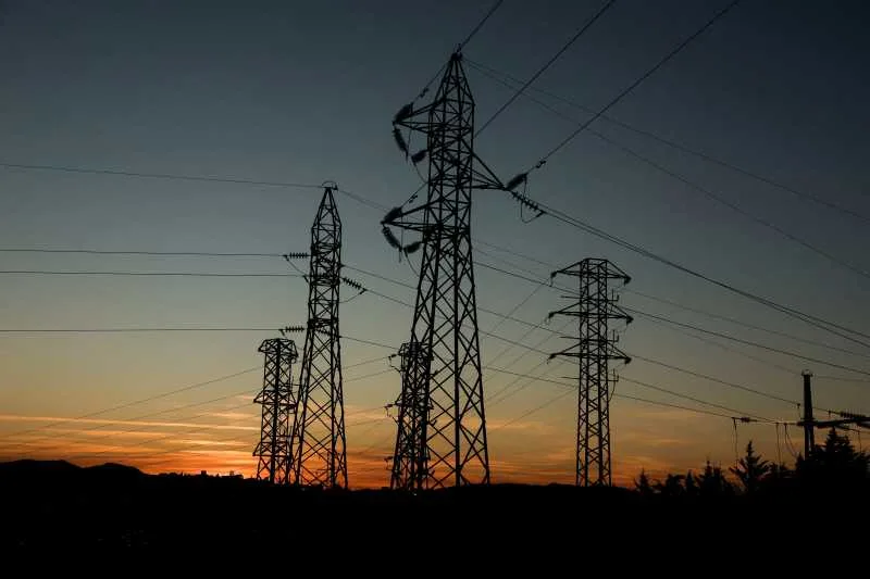 Turnuri de electricitate la apus, simbolizând problemele energetice din Spania.
