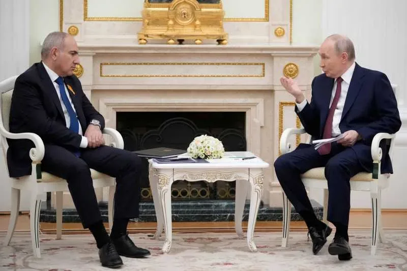 Vladimir Putin discutând cu un oficial armean despre relațiile economice.