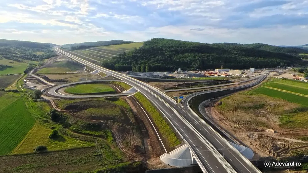 Peisajul autostrăzii Transilvania, aproape de finalizare, cu lucrări în desfășurare.