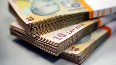 Bancnote de 10 lei aranjate pe o masă, simbolizând economia românească.