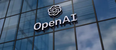Clădirea OpenAI cu logo pe fațadă, reflectând cerul.