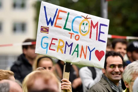 Oamenii protestează cu un banner colorat în Germania.