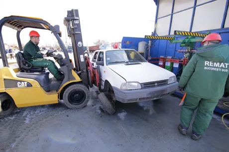 Proces de reciclare a unei mașini vechi la un centru de dezmembrări auto.