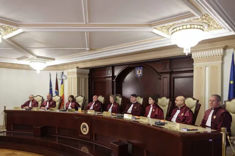 Ședință a Curții Constituționale cu judecători în robe roșii.