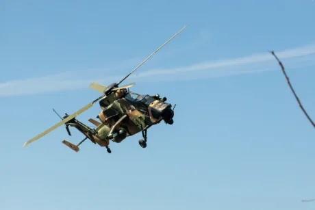 Elicopter Eurocopter Tiger în zbor, cu un cer senin în fundal.